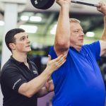 Conor Helping Client With Exercise